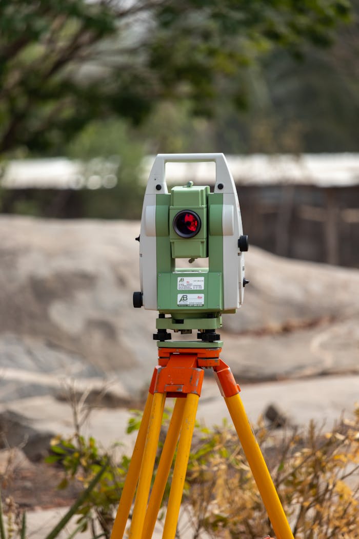 who-we-are A surveying theodolite set on a tripod outdoors in Dassa, Benin, ideal for civil engineering projects.